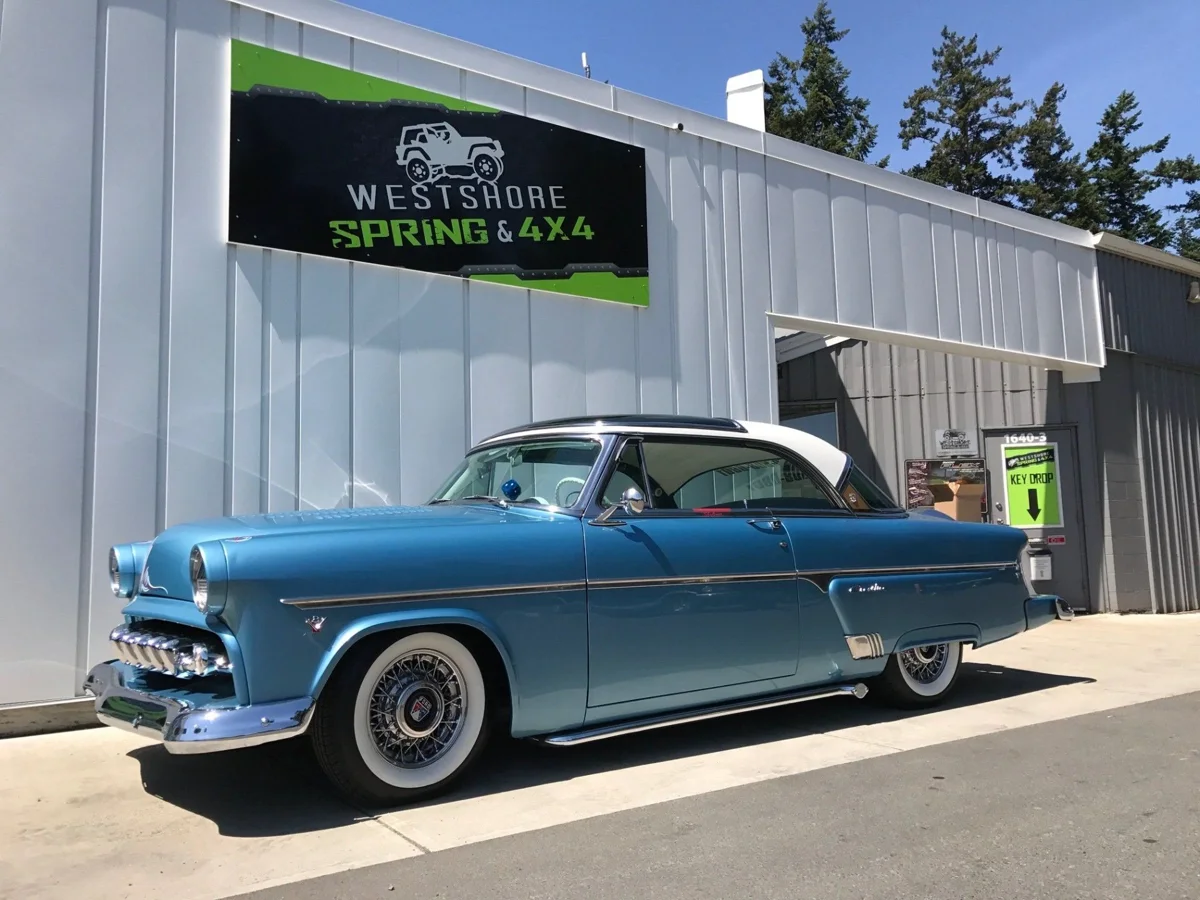 Blue classic car outside Westshore Spring and 4x4
