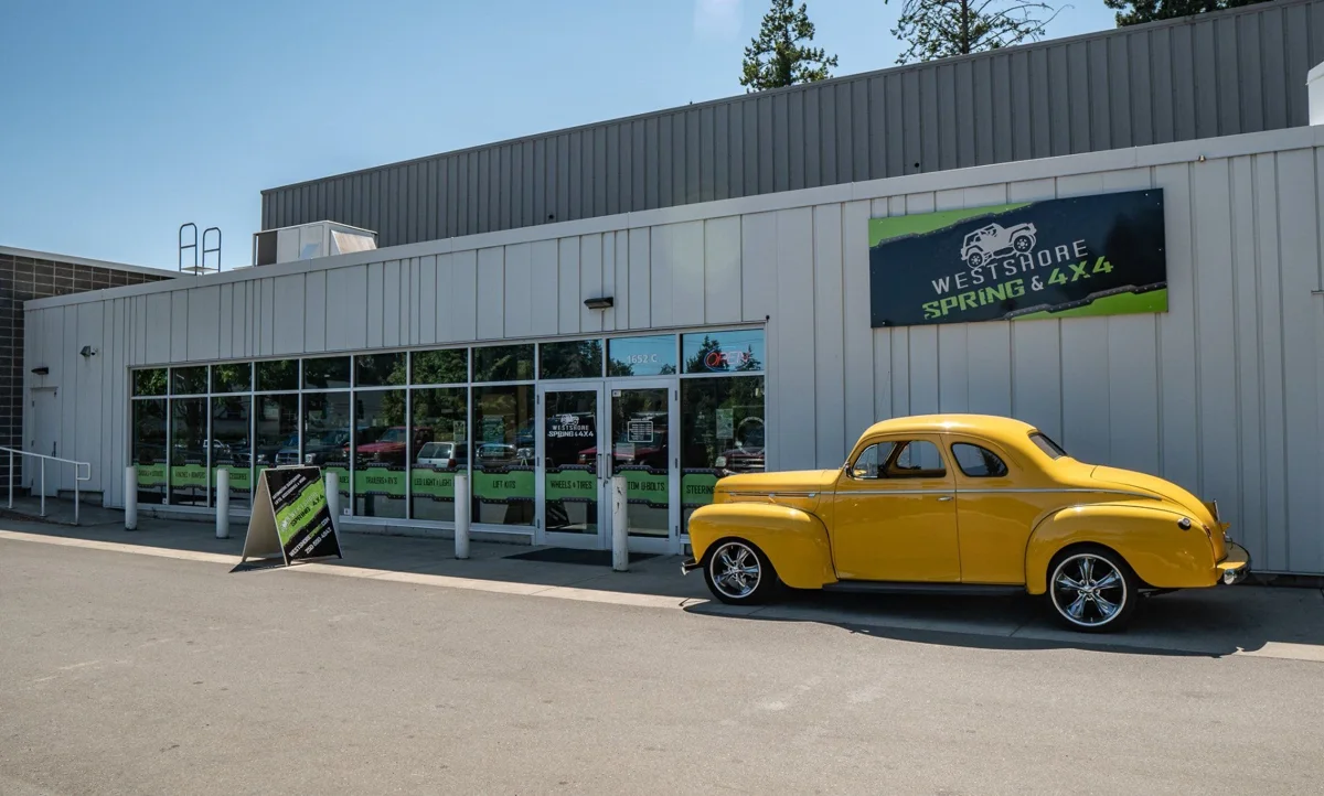 Exterior of Westshore Spring and 4x4 with a yellow classic car